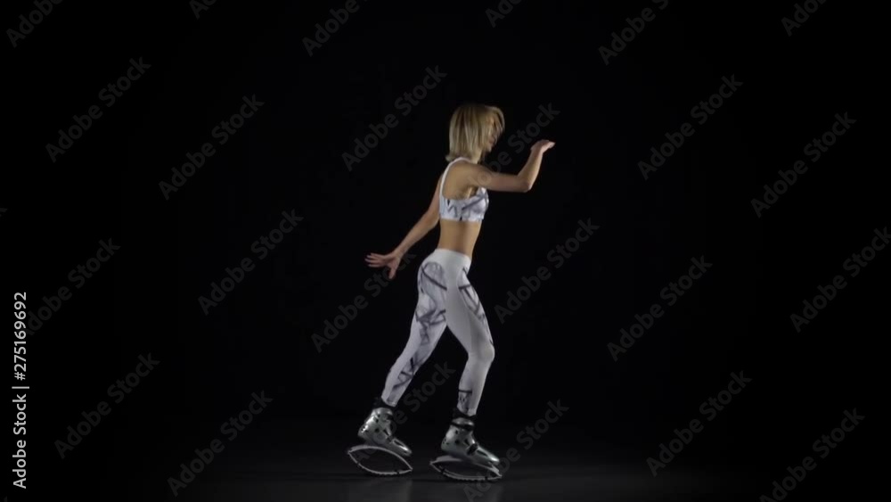 Slow motion, fitness instructor performing exercises in kangoo jumps shoes. Slow motion, fitness instructor performing exercises in kangoo jumps shoes.