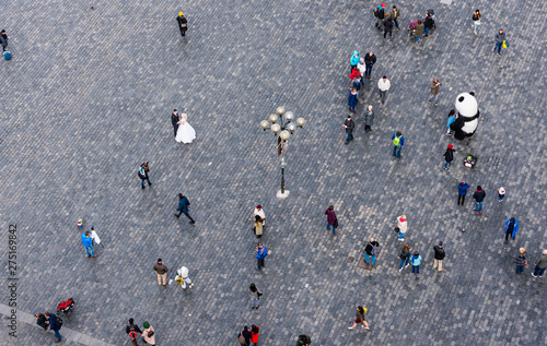 Bird's eye view of a square with people and a bride and groom