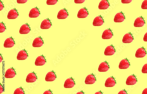 Flat lay composition with strawberry berry on a yellow background