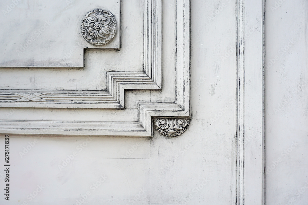 Fragment of a wooden carved door painted with white paint. Architectural background with empty space Fragment of a wooden carved door painted with white paint. Architectural background with empty space