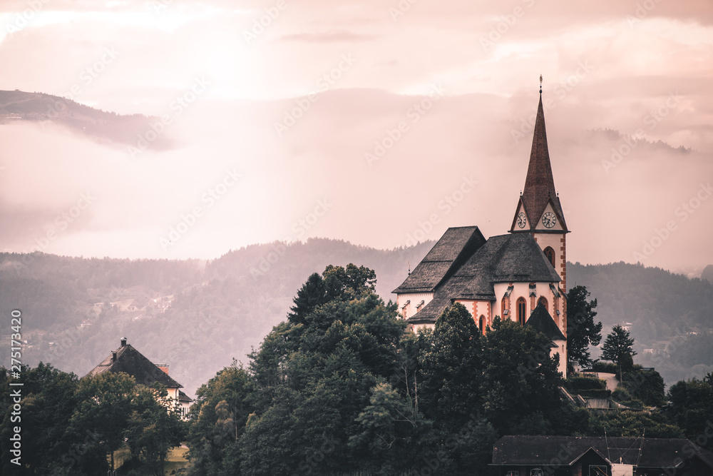 Obraz premium the Church of Maria Woerth at lake woerthersee at sunrise