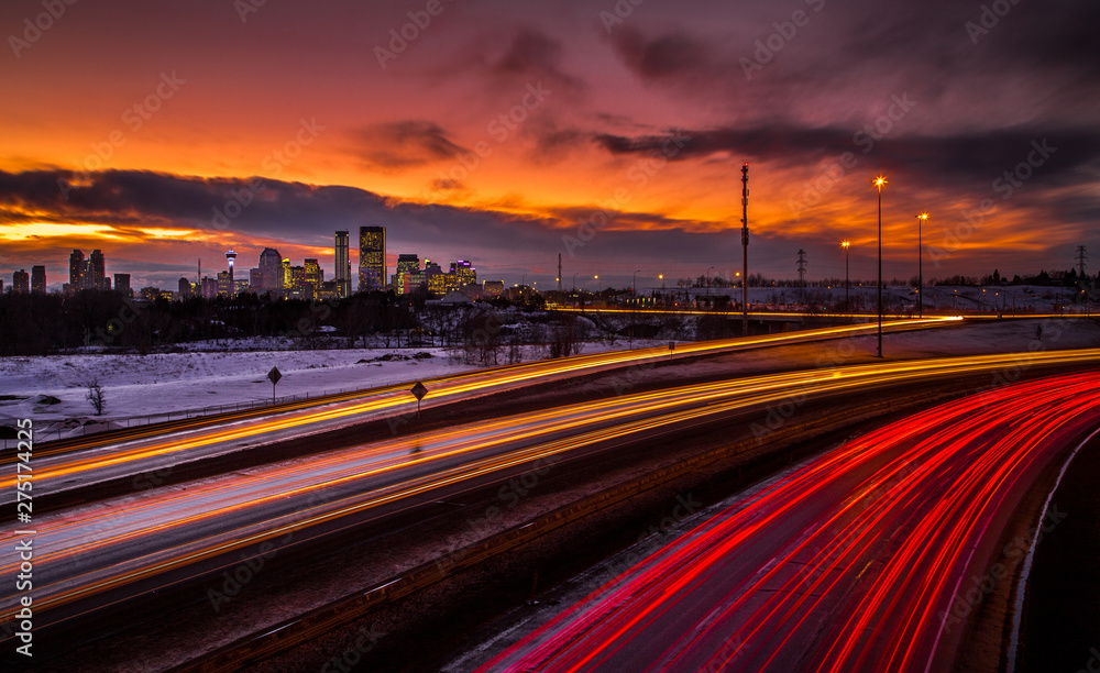 Traffic during sunset with city