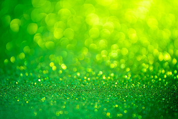 Green glitter christmas abstract background. Defocused sequin light.