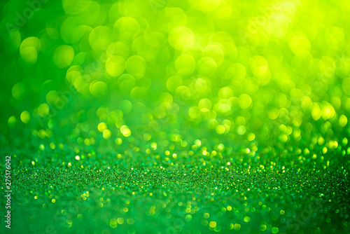 Green glitter christmas abstract background. Defocused sequin light.