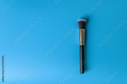 Makeup brush on a blue background