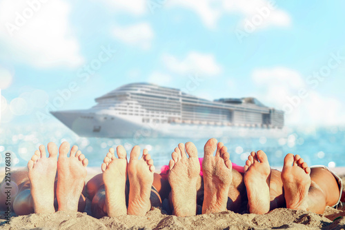 Group of friends having fun on the beach with their foots. Concept of summertime. photo