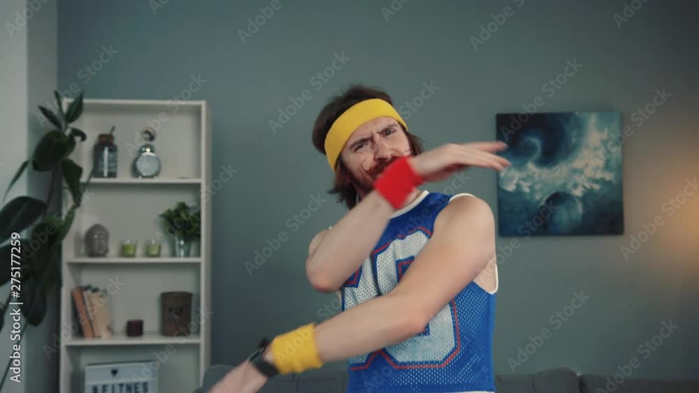 Portrait of handsome retro funny guy in sports clothes looking on the viewer with respect waving hands and smiling cheerfully indoors at home. Portrait of handsome retro funny guy in sports clothes looking on the viewer with respect waving hands and smiling cheerfully indoors at home.