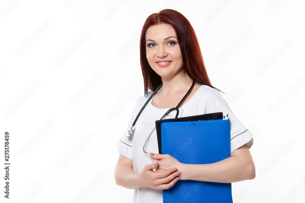 Happy young female family doctor holds blue folder with documents, has friendly expression, isolated white background. Medicine concept. Happy young female family doctor holds blue folder with documents, has friendly expression, isolated white background. Medicine concept.