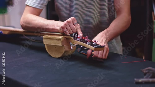 Luthier change strings of bass guitar