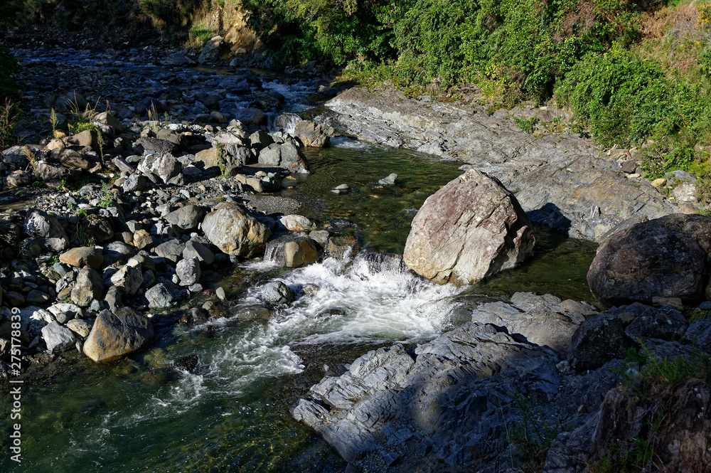 The river flows over rocks and past boulders The river flows over rocks and past boulders
