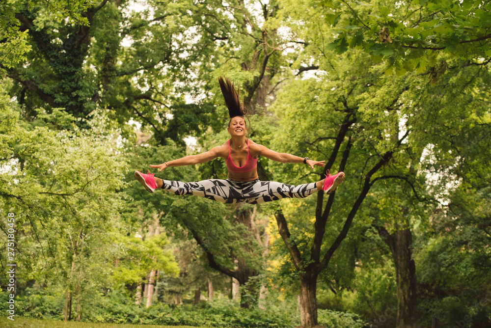 A beautiful fitness girl trains in the park. Nature and healthy life A beautiful fitness girl trains in the park. Nature and healthy life
