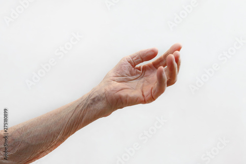 Old lady's hand. Elderly lady is waiting for help. Elderly concept with light background. photo