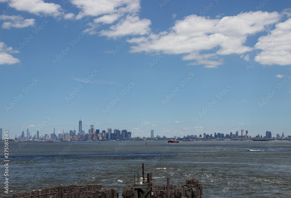 Piles in the port of New York, on the background are the skyscrapers of Manhattan. Skyscrapers are seen in the bay bay.