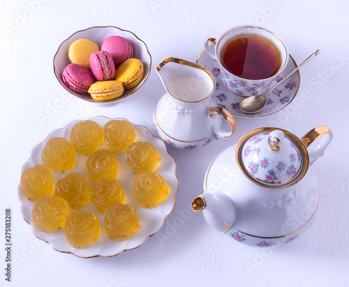 Porcelain tea set with milk, macaroni and marmalade.