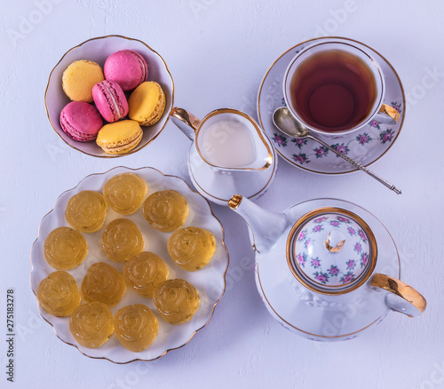 Porcelain tea set with milk, macaroni and marmalade.