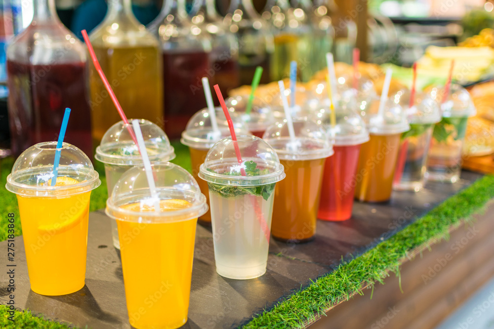Many different colorful cocktails in plastic cups with tubes. Many different colorful cocktails in plastic cups with tubes.