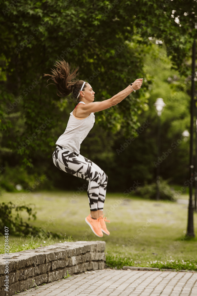A beautiful fitness girl trains in the park. Nature and healthy life A beautiful fitness girl trains in the park. Nature and healthy life