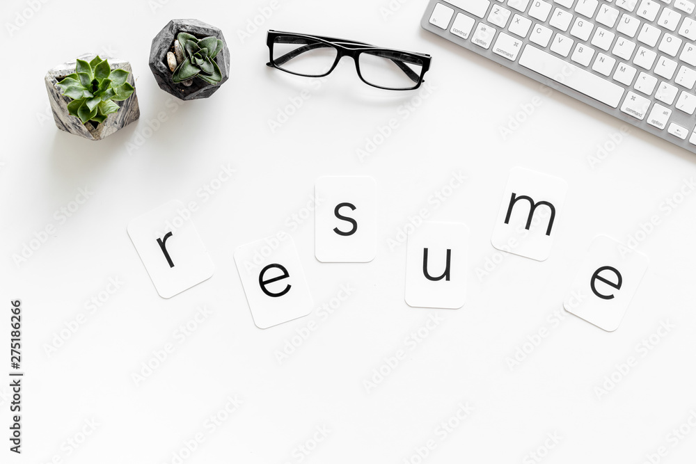 Resume copy on work place with keyboard and glass on white desk background top view Resume copy on work place with keyboard and glass on white desk background top view