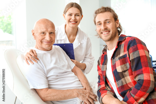 Young man visiting his elde...