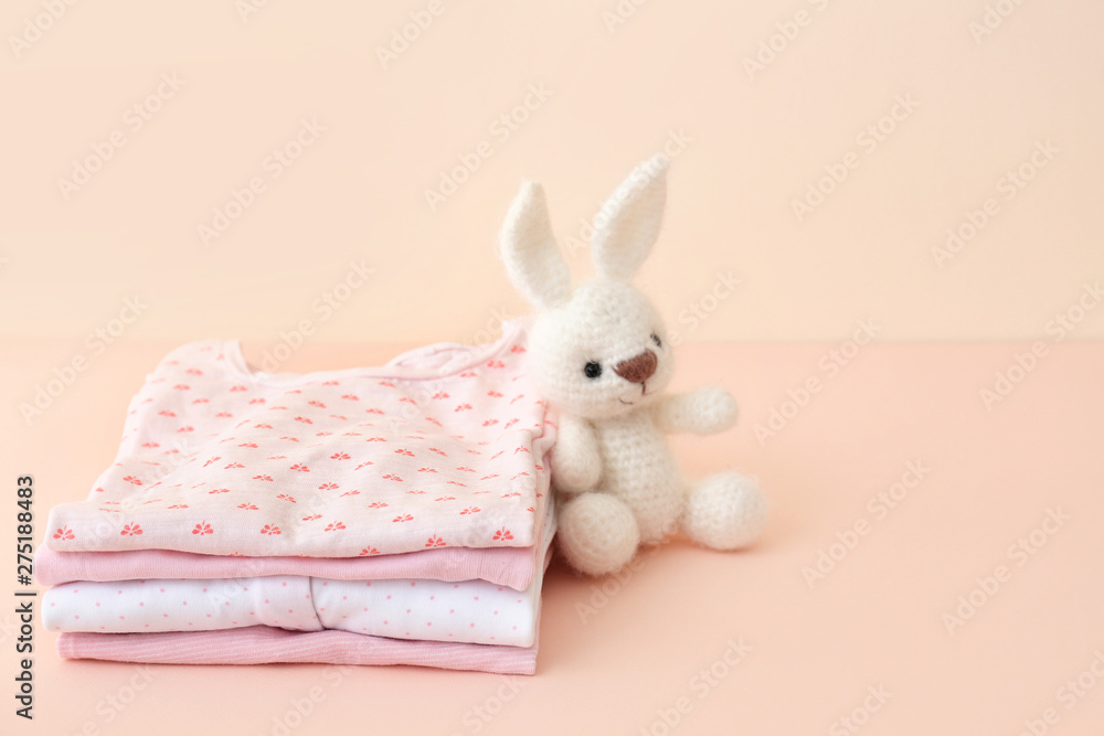 Obraz premium Stack of baby clothes on color background