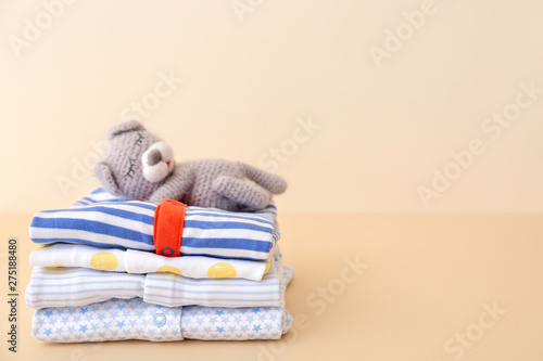 Konstfotografi Stack of baby clothes on color background