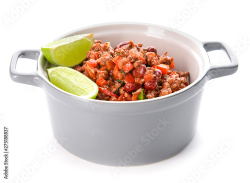 Pot with tasty chili con carne on white background