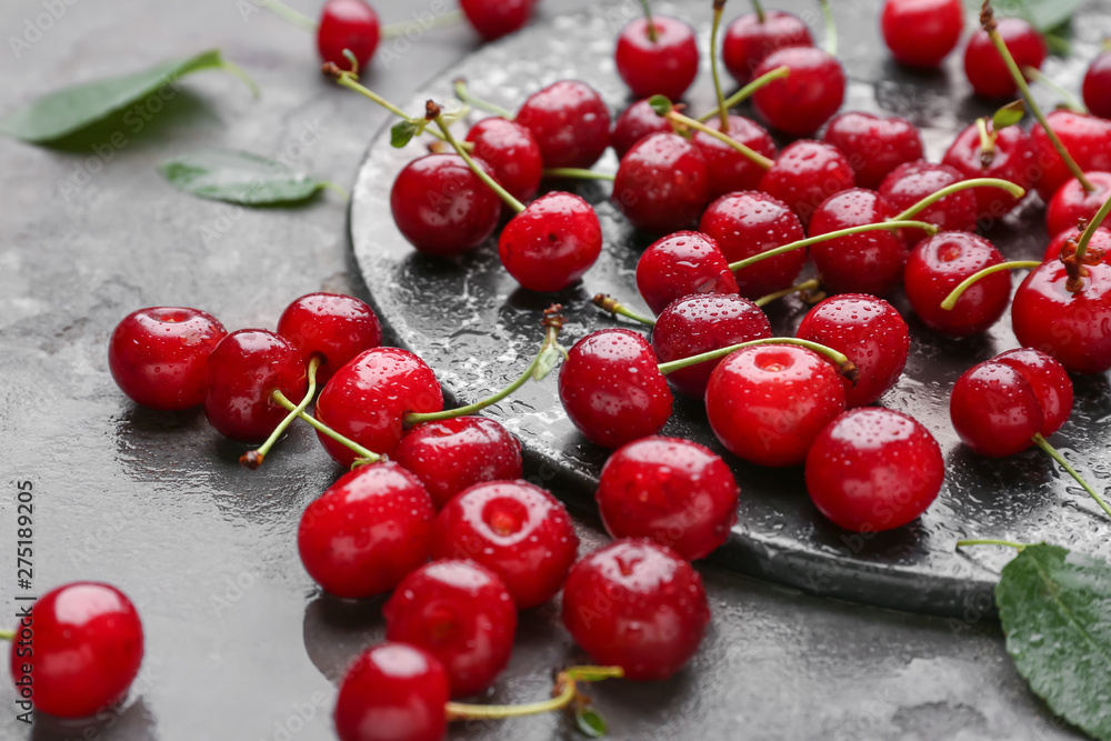 Tasty ripe cherry on grey background Tasty ripe cherry on grey background
