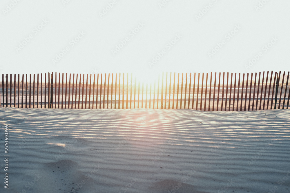 Beach Sunset with fence and footsteps