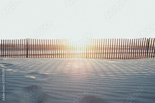 Beach Sunset with fence and footsteps