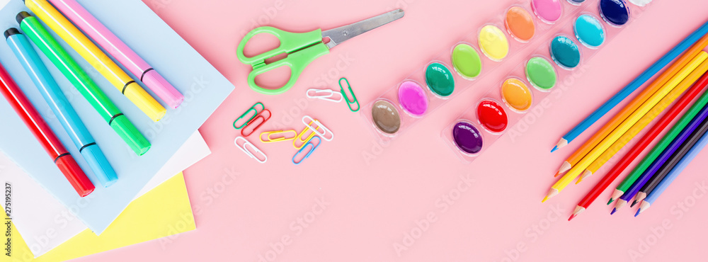 School supplies stationery, colour pencils, paints, paper on pink background, back to school concept with free copy space for text, modern elementary education. Kids desk, flat lay, top view, mockup. School supplies stationery, colour pencils, paints, paper on pink background, back to school concept with free copy space for text, modern elementary education. Kids desk, flat lay, top view, mockup.