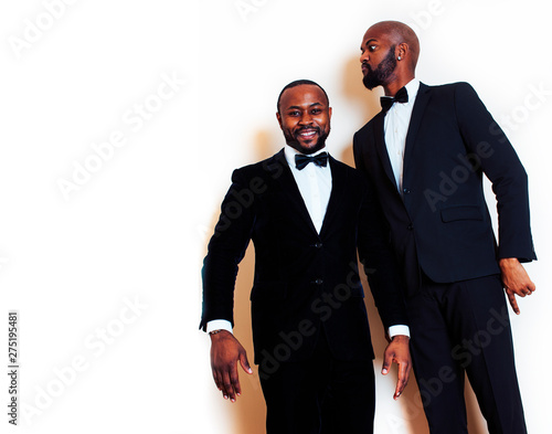 two afro-american businessmen in black suits emotional posing, gesturing, smiling. wearing bow-ties, lifestyle people concept photo