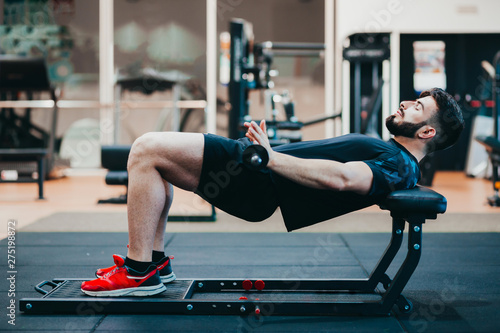 Man training glutes in the gym