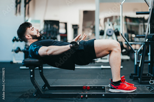 Man training glutes in the gym