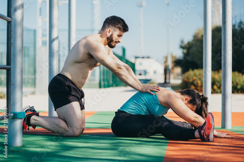 couple stretching together on the street