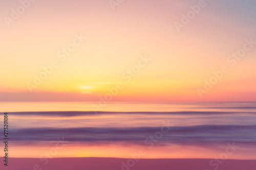 Motion blur tropical sunset beach with bokeh sun light wave abstract background. © tonktiti