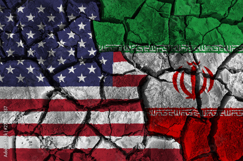 Crisis and confliction concept of america and iran . flags on cracked ground background .