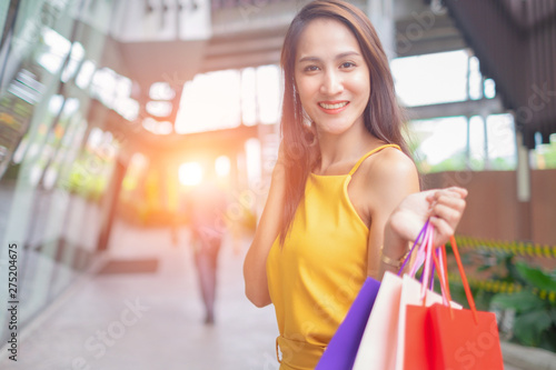 Beautiful women with shopping bags enjoying in shopping standing outdoors of shopping mall, shopping concept