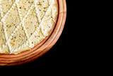 Half a pizza on top of a black background in close up