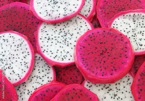 Red and white dragon fruits slices background, pitaya fruit texture