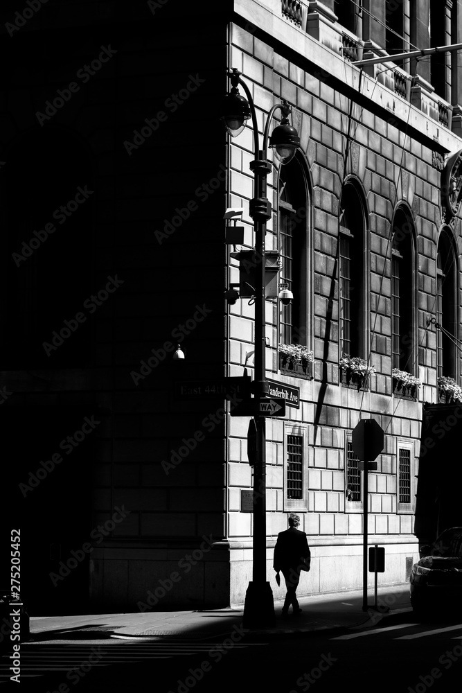 Midtown Manhattan street with man walking in black and white photo