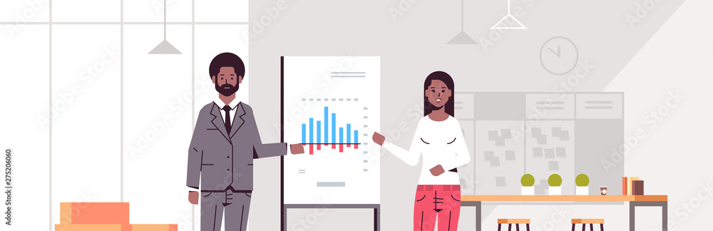 coworkers presenting financial graph on flip chart african american business couple at conference meeting making presentation concept modern office interior flat portrait horizontal coworkers presenting financial graph on flip chart african american business couple at conference meeting making presentation concept modern office interior flat portrait horizontal