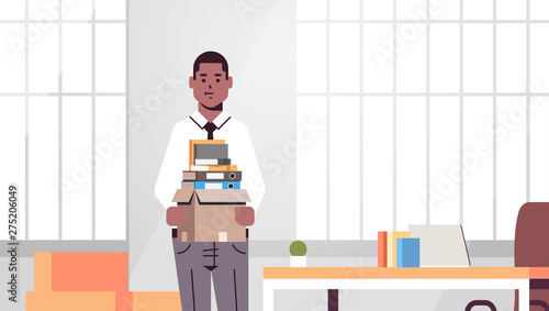 african american businessman office worker holding box with stuff things new job business concept creative workplace modern office interior flat portrait horizontal