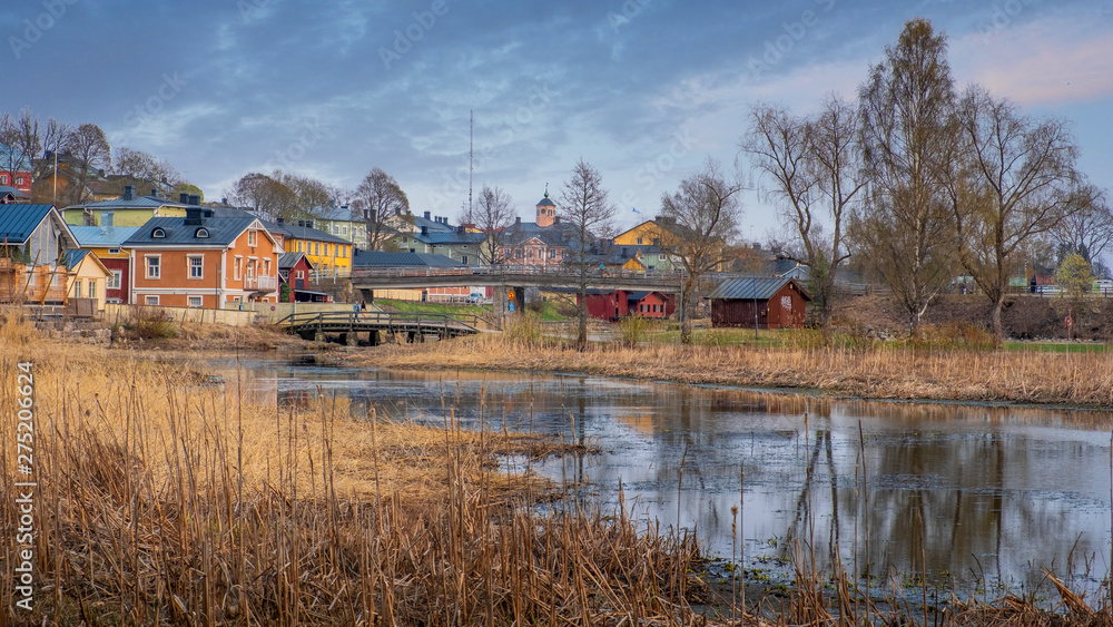 Panorama of the ancient historical city of Porvoo in Finland at sunset, Wooden houses, river, bridge, among the northern nature in the evening