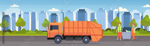 orange garbage truck urban sanitary vehicle couple workers in uniform loading recycling bins waste recycling concept modern cityscape background flat horizontal banner