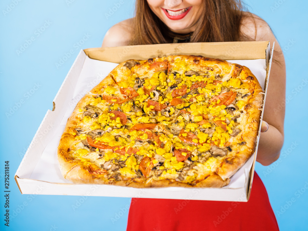 Woman holding big pizza in box