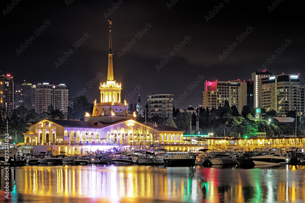 sochi city russia sea marina at night cityscape landmark view of port building and hotel towers on landscape background with lights on resort embankment with leisure ships moored to pier