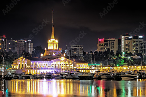 sochi city russia sea marina at night cityscape landmark view of port building and hotel towers on landscape background with lights on resort embankment with leisure ships moored to pier