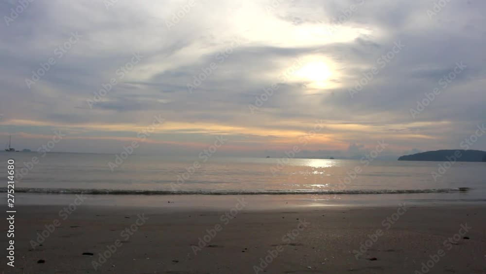Ao Nang Beach at sunset, gentle waves lap at sand, Krabi, Thailand Ao Nang Beach at sunset, gentle waves lap at sand, Krabi, Thailand