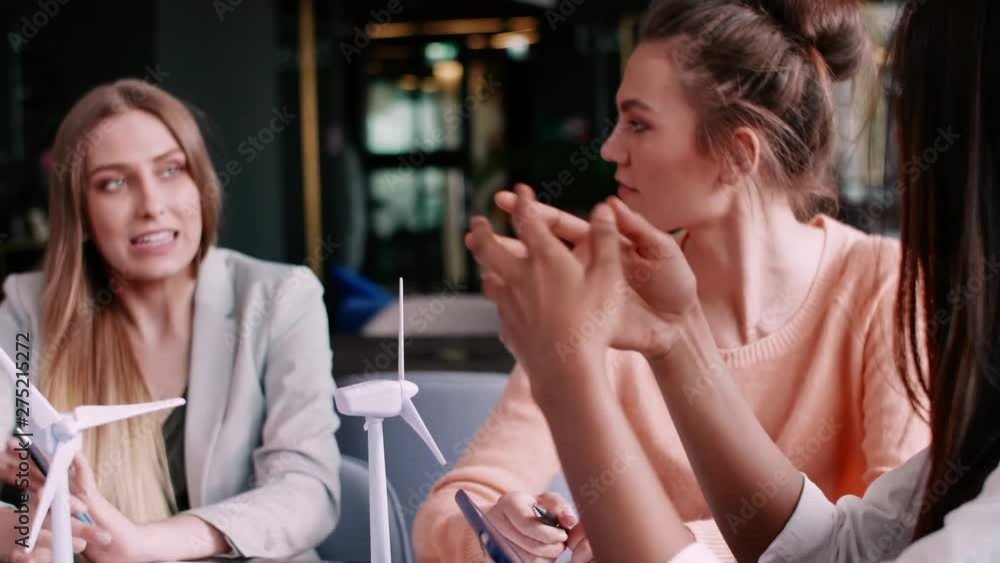 Female coworkers having a conversation at a business meeting Female coworkers having a conversation at a business meeting