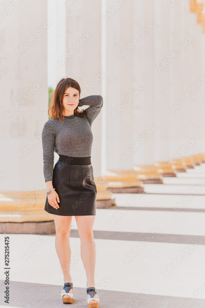 Woman in lurex combidress or bodysuit and black leather skirt, concept of fashionable clothes Woman in lurex combidress or bodysuit and black leather skirt, concept of fashionable clothes